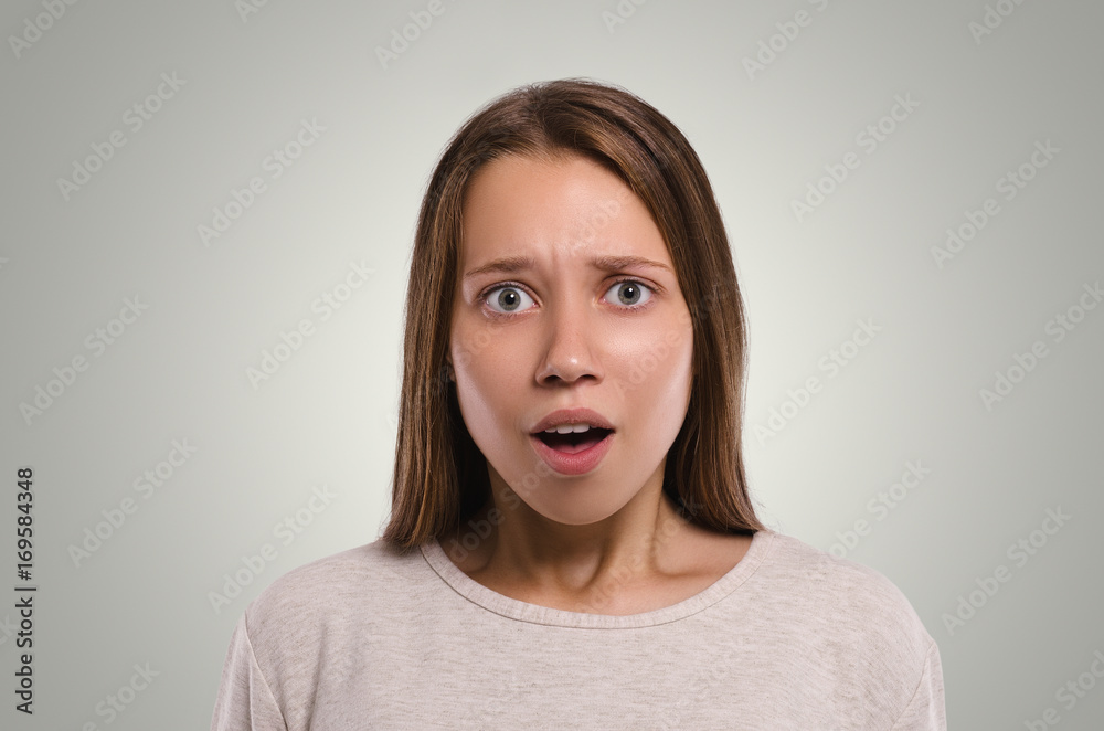 Beautiful female looking at camera. Shocked girl. Attractive young girl portrait. Healthy woman studio portrait. Beautiful female looking at camera. Shocked girl. Attractive young girl portrait. Healthy woman studio portrait.