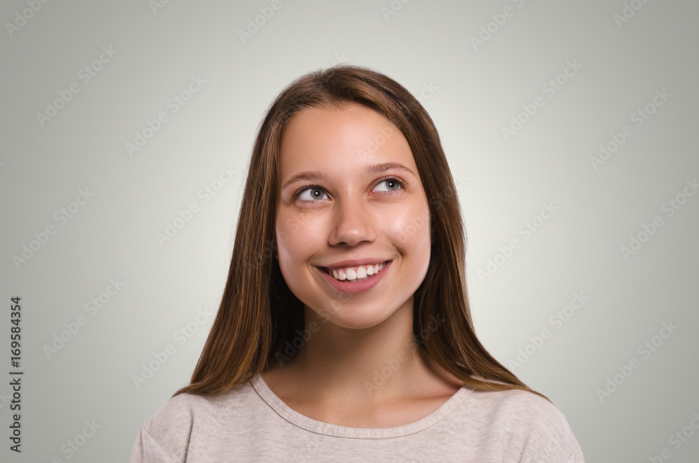Beautiful female looks away. The girl has an idea. Attractive young girl smiling portrait. Healthy woman studio portrait. Beautiful female looks away. The girl has an idea. Attractive young girl smiling portrait. Healthy woman studio portrait.