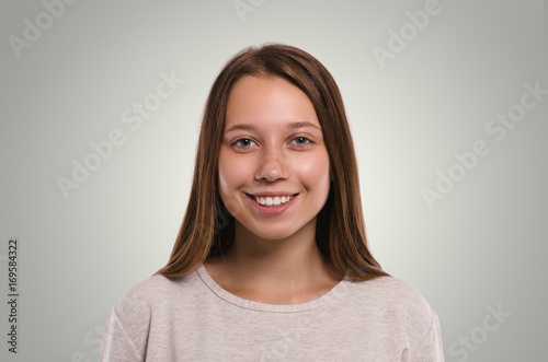 Beautiful  female looking at camera. Smiling girl. Attractive young girl portrait.  Healthy woman studio portrait.