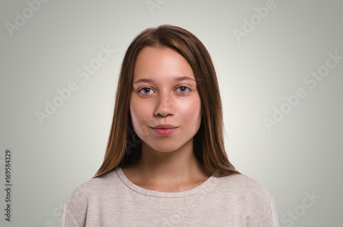 Beautiful  female looking at camera. Attractive young girl portrait.  Healthy woman studio portrait.
