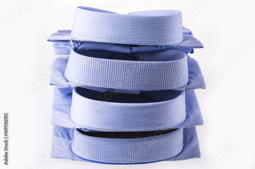 Men's shirts folded in a pack on a white background