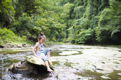 Little girl playing in the mountain stream © hakase420