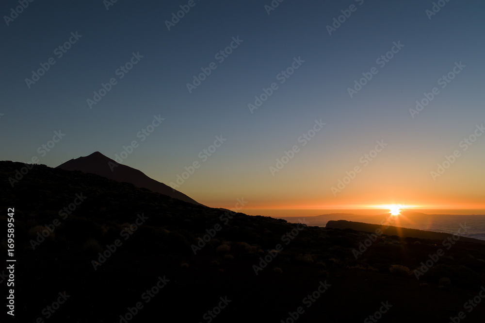 Sunset at the highest mountain of Spain, the Montaña Teide in Tenerife, with sea of clouds seen from the Teide observatorium Izaña.