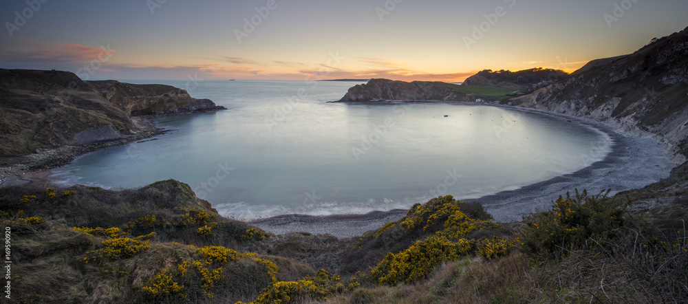 Lulworth Cove at sunset on the Jurassic Coast in Dorset. Lulworth Cove at sunset on the Jurassic Coast in Dorset.