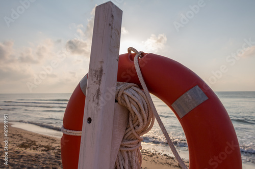 Bild auf Leinwand Life preserver on a beach at sunrise (Guardamar del Segura, Spain)