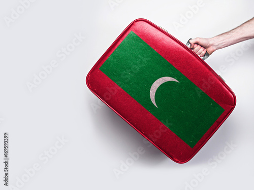 Maldives flag on a vintage leather suitcase.