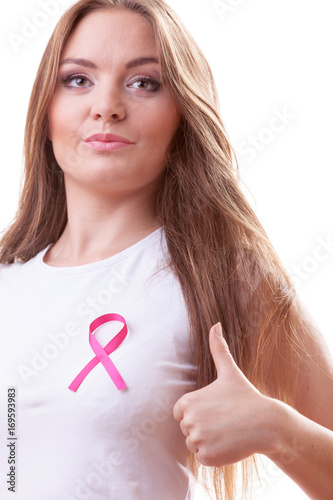 woman pink cancer ribbon on chest making thumb up © Voyagerix