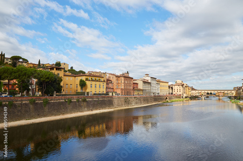 Quay of the Arno River and Ponte Vecchio Bridge in Florence, Italy on a summer sunny day 