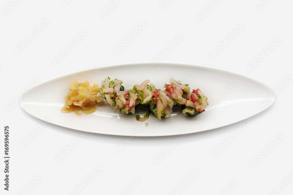 Hamachi negi Maki on white plate and white background Hamachi negi Maki on white plate and white background