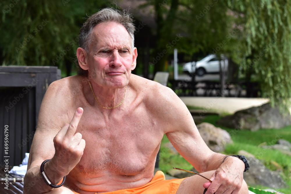 Foto de Angry shirtless old man giving the finger do Stock | Adobe Stock