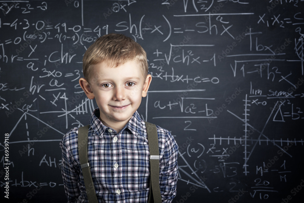 Caucasian child with plaid shirt and braces in front of a classic slate school blackboard. happy and positive expression. Caucasian child with plaid shirt and braces in front of a classic slate school blackboard. happy and positive expression.