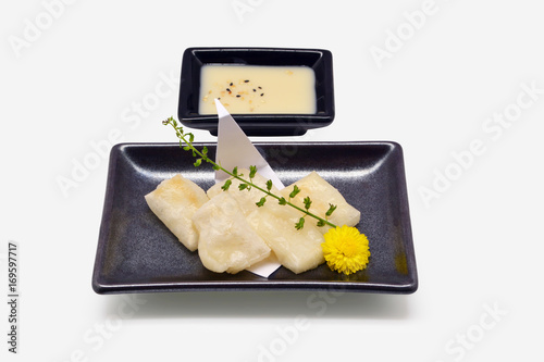 Mochi Yaki (Grilled Japanese Mochi Flour) in Black Plate on White Background photo