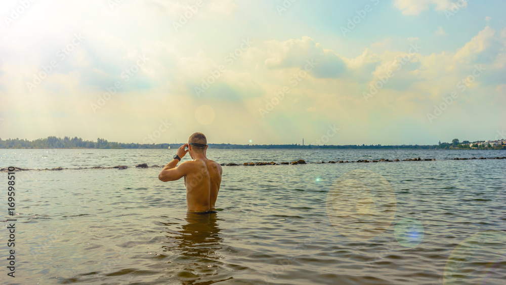 Man preparing for an openwater swim in a lake 