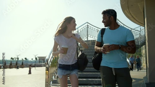 Amused smiling couple sharing emotions being outside