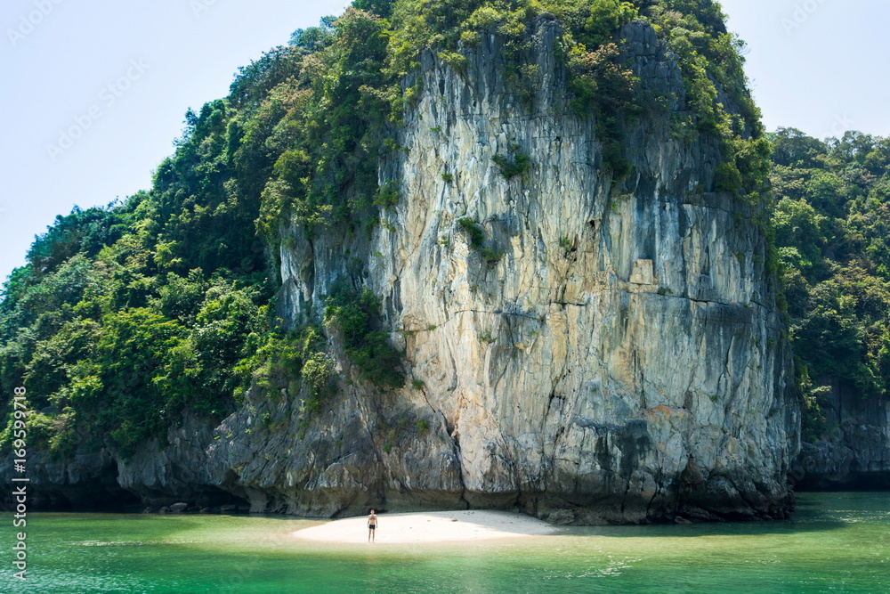 Man standing in the remote beach of Halong bay, Vietnam