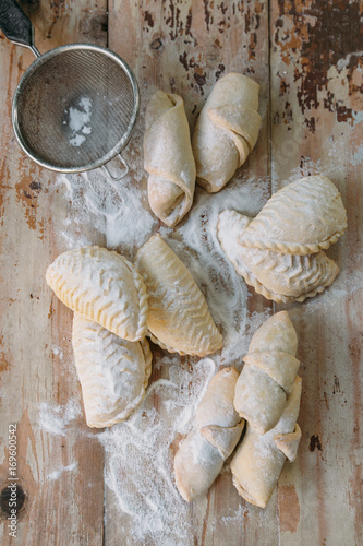 Roll cookies with nuts on a wooden table. Georgian dessert. Croissants, pastry rolls. photo