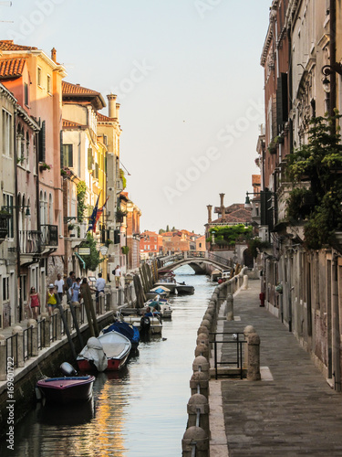 Venice  Italy - Circa July 2015  Tourists and boats at sunset in the canals of Venice