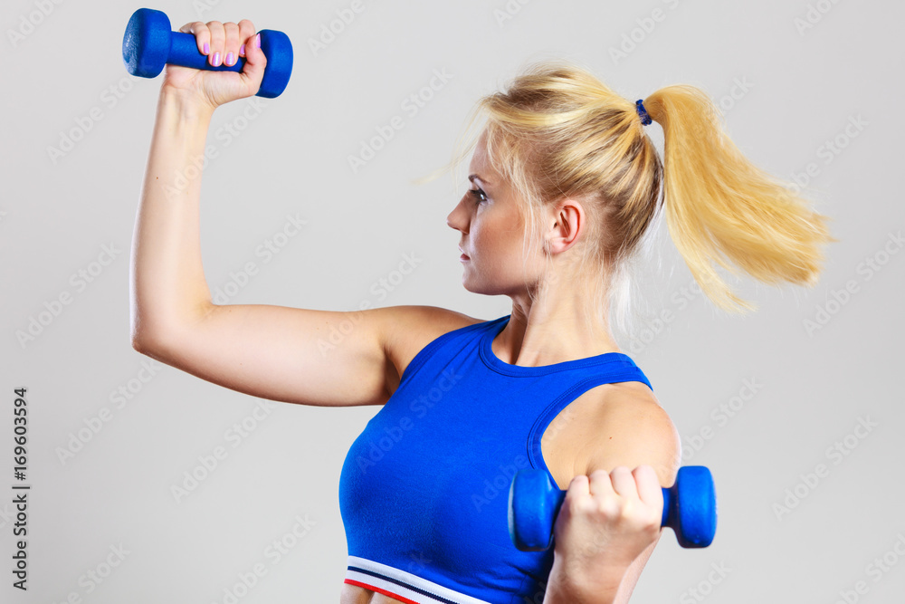Fit woman lifting dumbbells weights Fit woman lifting dumbbells weights