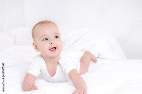 Infant child baby girl lying happy smiling on blanket