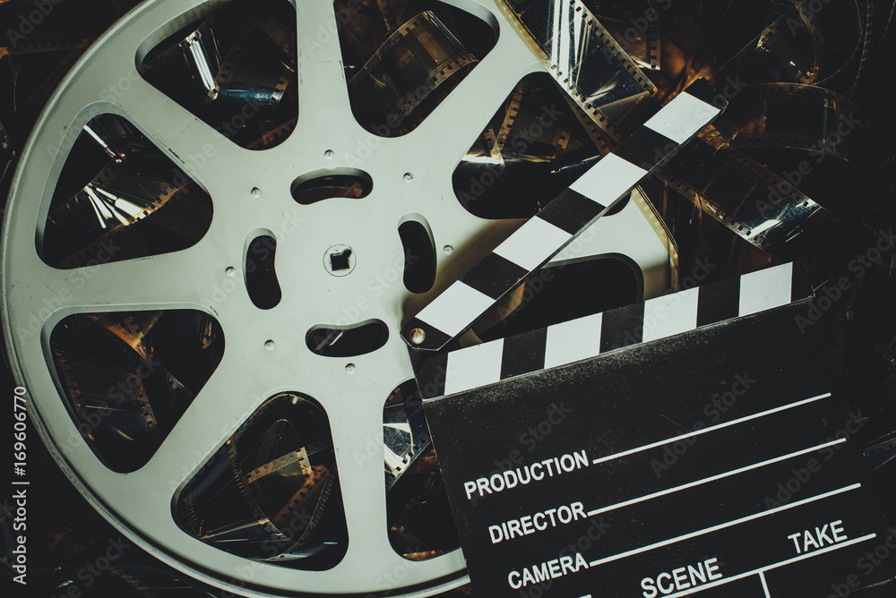 Fototapeta premium Vintage movie background, reel filmstrip and clapper board