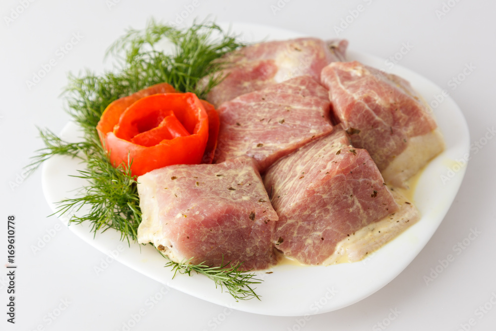 Raw pork beef meat on the white plate Raw pork beef meat on the white plate