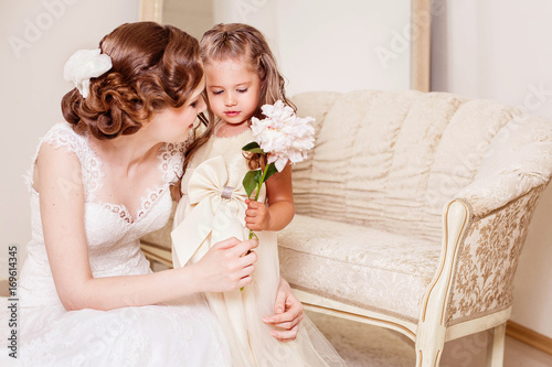 Shy flower girl gives a flower to bride. Wedding. Just married. Kids at the wedding. Wedding hairstyle