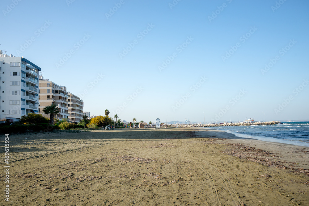 Empty off season Kastela beach in Larnaca with MacKenzie Marina in background
