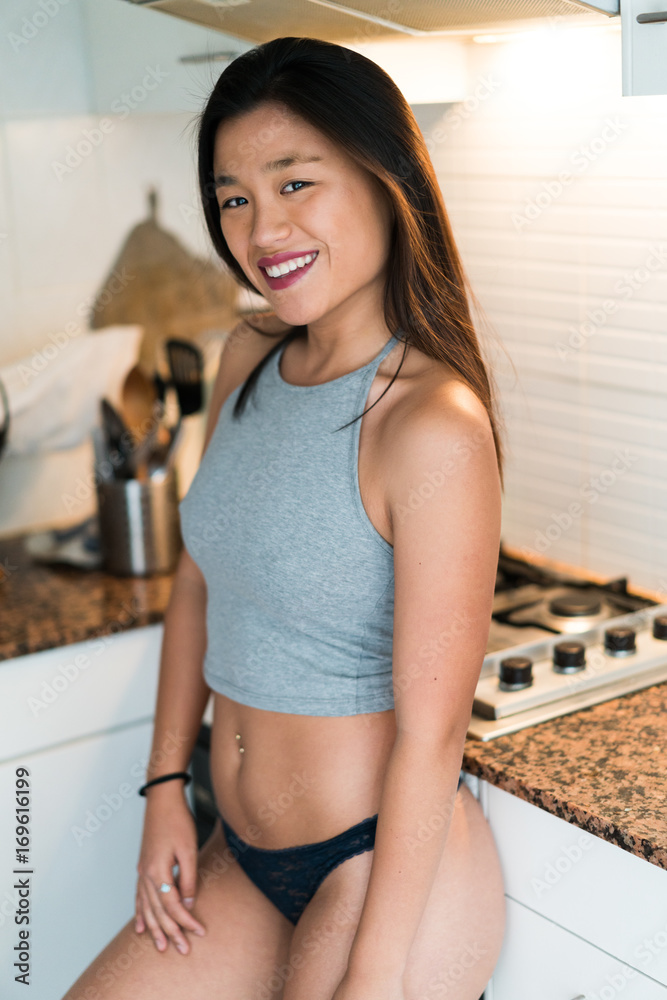 Sexy Chinese woman at the kitchen Stock Photo | Adobe Stock