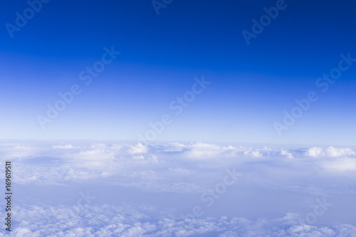 clear blue sky background with white beautiful clouds. View from the window airplane. Travel concept