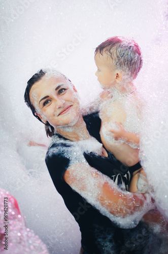 A young mother with a child at a foam show