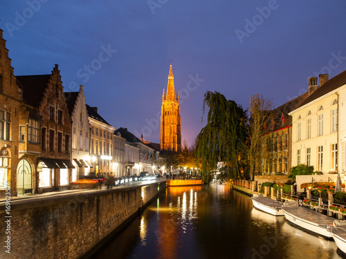 Church of Our Lady and water canal by night  Bruges  Belgium.