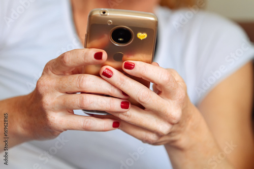 Close-up of woman hands using a smartphone © simonmayer