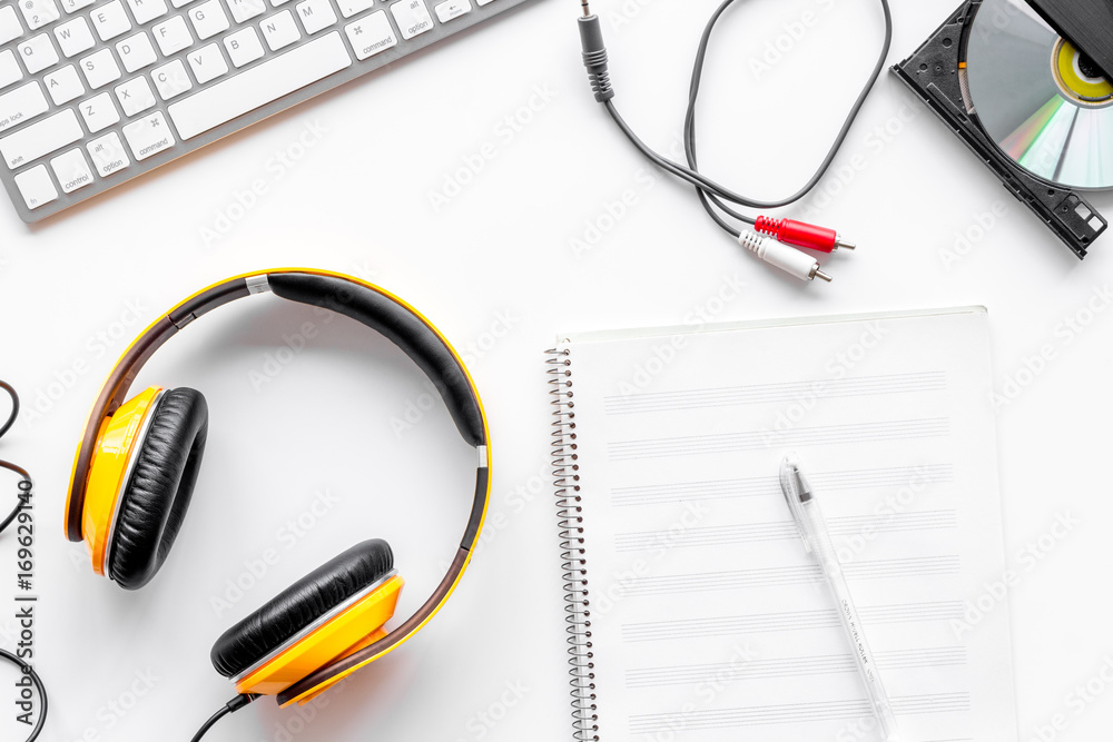 Headphone with white paper note in music studio for dj or musician work on white background top view mock-up Headphone with white paper note in music studio for dj or musician work on white background top view mock-up