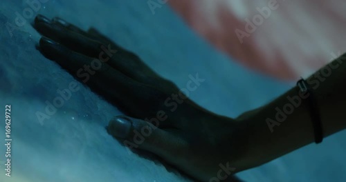 Women removes hand from ice with lightshow - cool exhibit