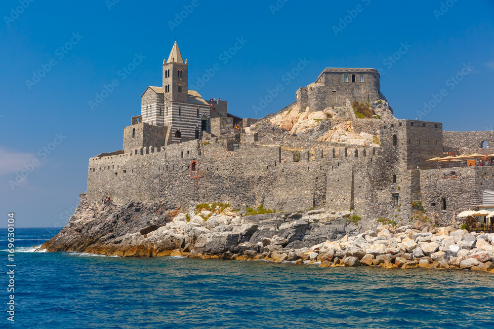 View from sea of Porto Venere with Gothic Church of St. Peter, Italian Riviera, Liguria, Italy.