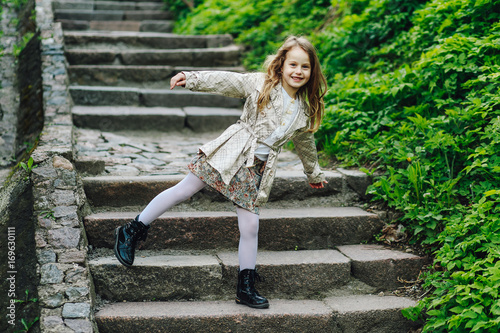 Happy funny girl standing on one leg and smiling © Vladimir