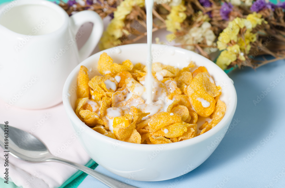 Corn flakes in a bowl with fresh milk for eating in the morning,breakfast or meal Corn flakes in a bowl with fresh milk for eating in the morning,breakfast or meal