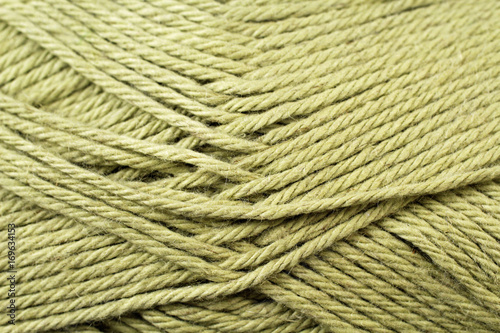 A super close up image of split pea green yarn