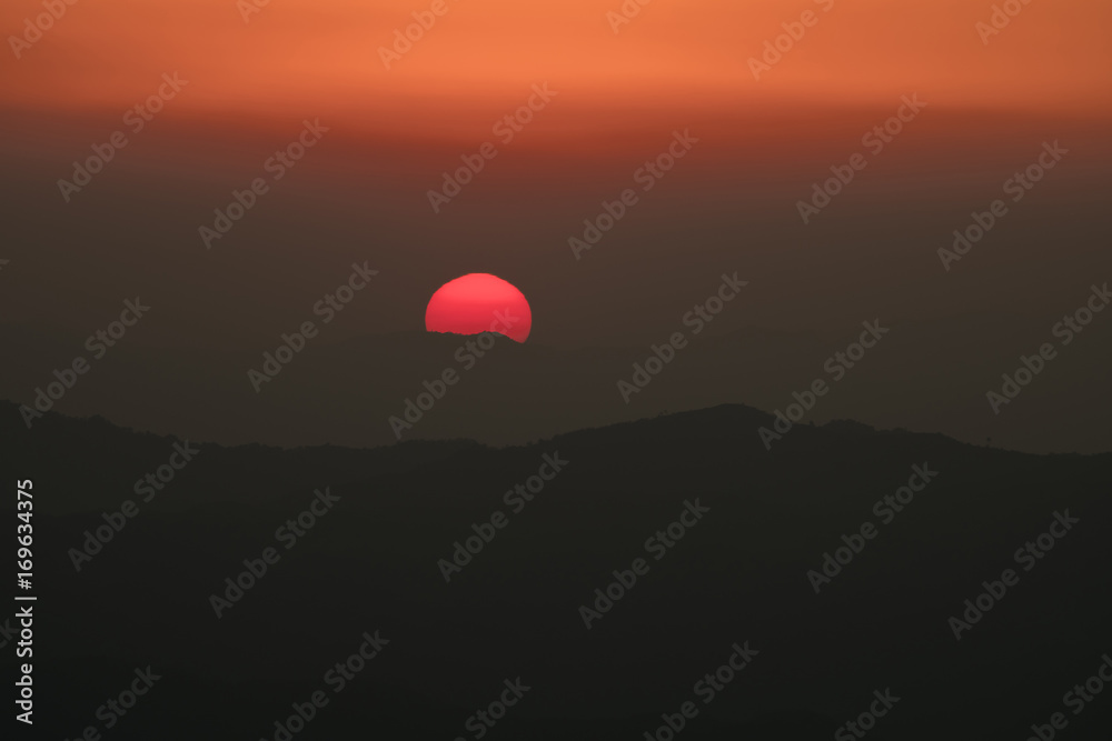 sun behind the mountains at sunset sun behind the mountains at sunset
