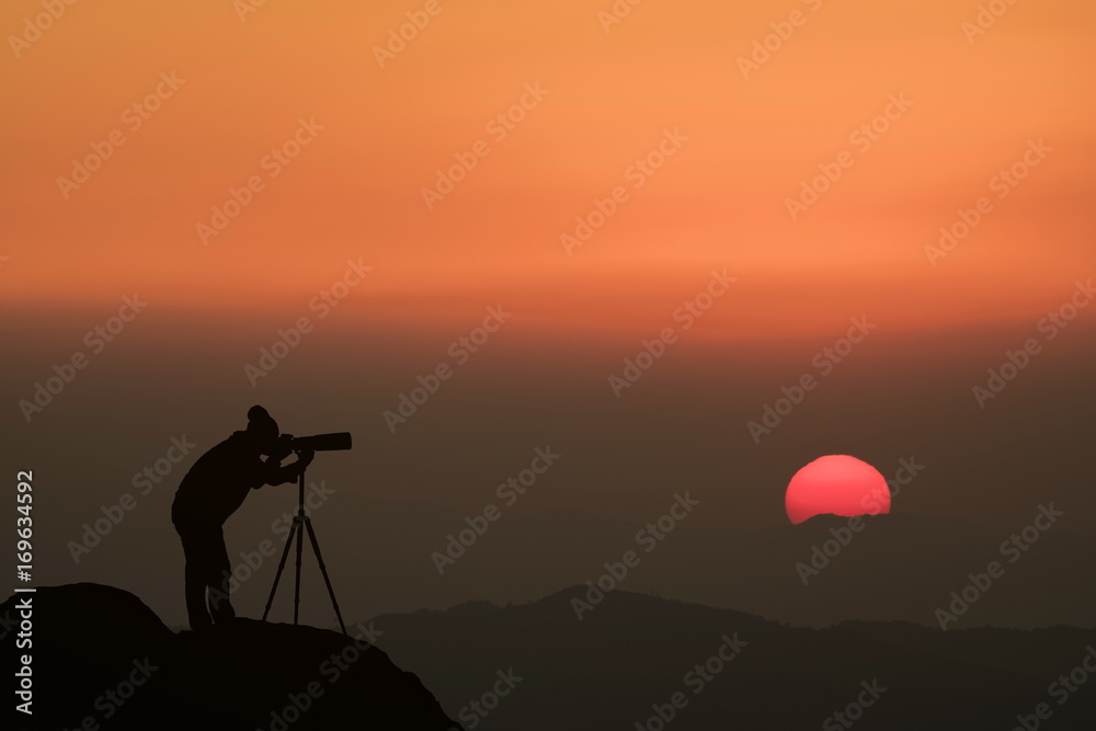 silhouette of a photographer who shoots a sunset