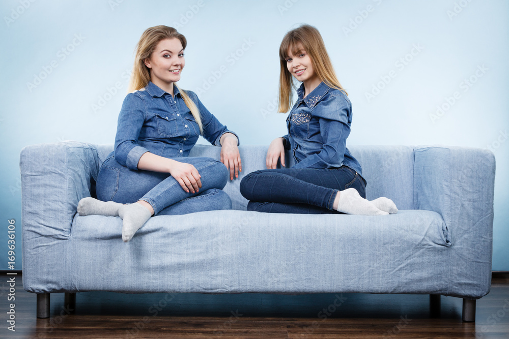 Two happy women friends wearing jeans outfit Two happy women friends wearing jeans outfit
