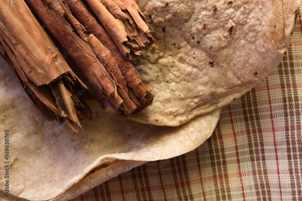 cinnamon sticks on dried tortilla in rustic style cinnamon sticks on dried tortilla in rustic style