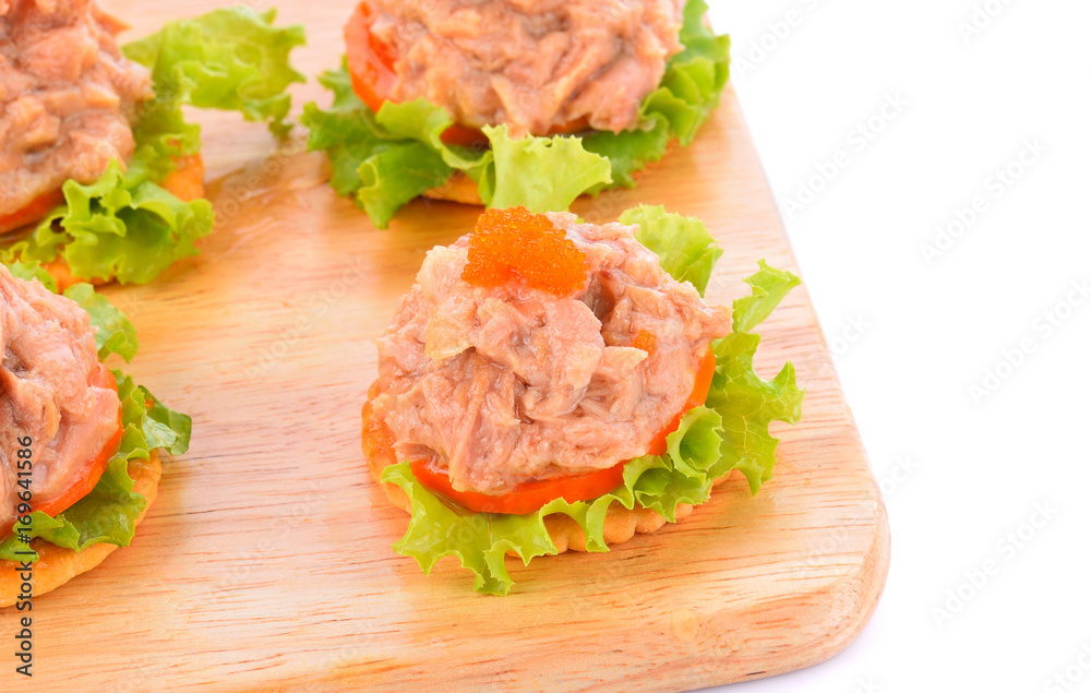 Tuna salad on a biscuit on a white background. Tuna salad on a biscuit on a white background.