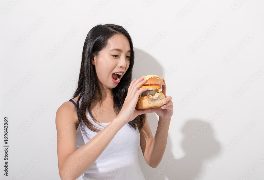 Happy woman eating burger