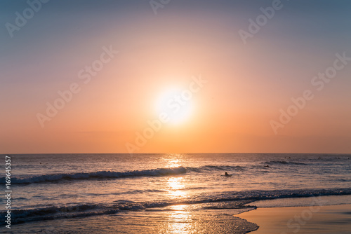 Water Sunset Background. Clear Tropical Island View and Sunset Beach Background. Sunset Waves and Amazing Landscape Ocean. Orange Ocean Beach. Sun rays in a Colorful Sunset Background. Beautiful Sky © Irina