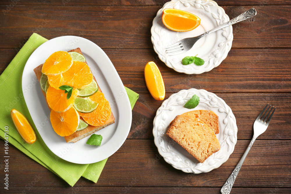 Delicious sliced citrus cake on wooden table Delicious sliced citrus cake on wooden table