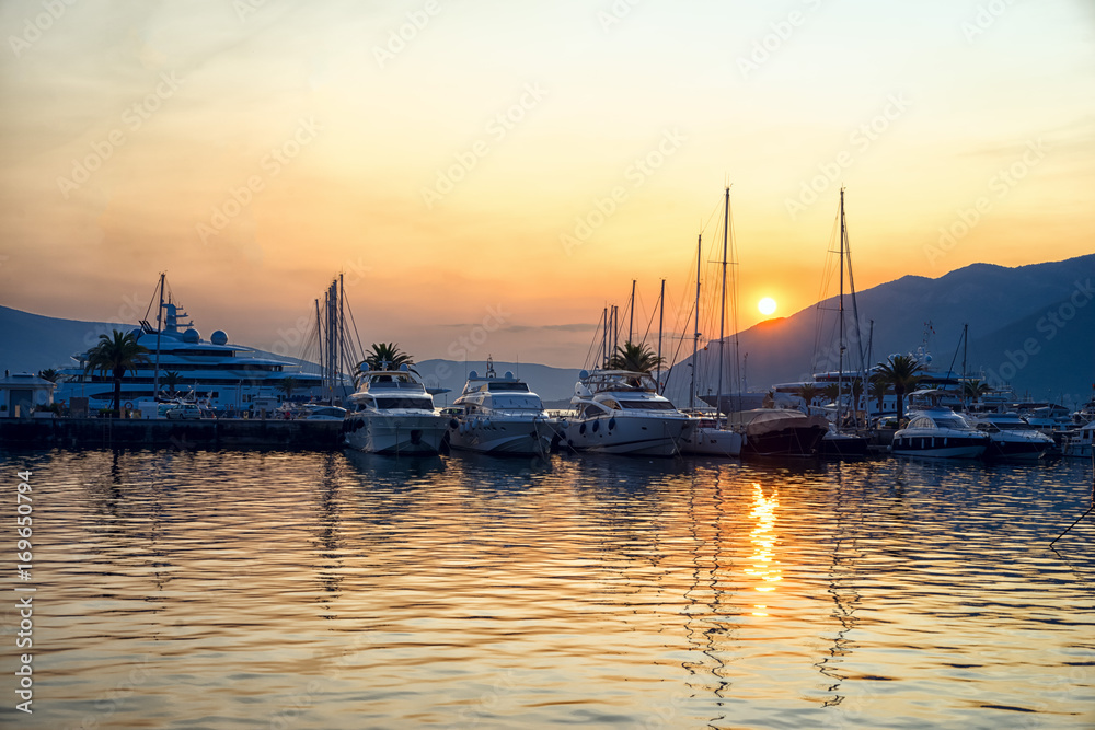 Sunset in Montenegro port. Yachts in a harbour.