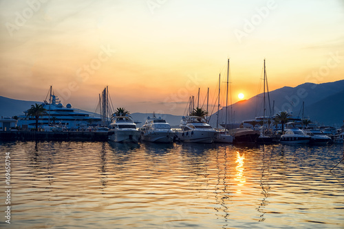 Fototapeta Naklejka Na Ścianę i Meble -  Sunset in Montenegro port. Yachts in a harbour.