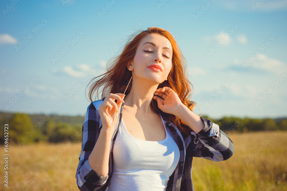 A tranquil and calm woman meditates relaxes and enjoys nature