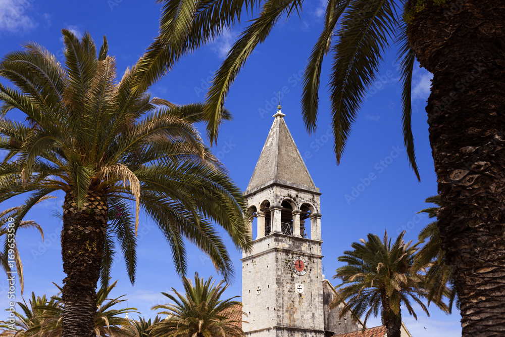 Old church and palm trees in Trogir, Croatia